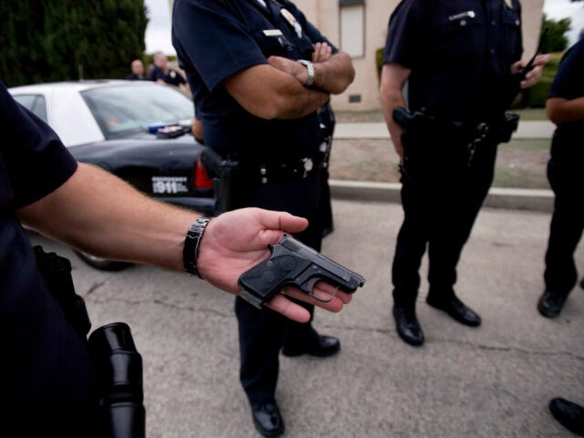 Los Angeles Police Department gang unit officers set up a small command center outside of