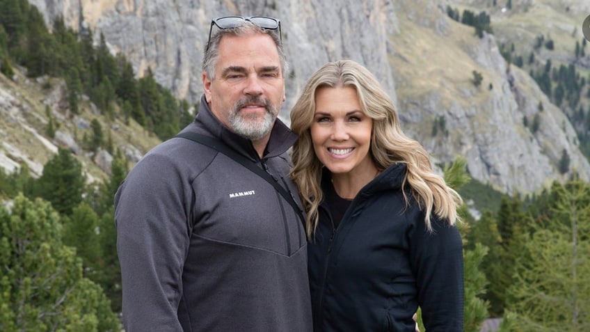 Couple poses together on a hike.