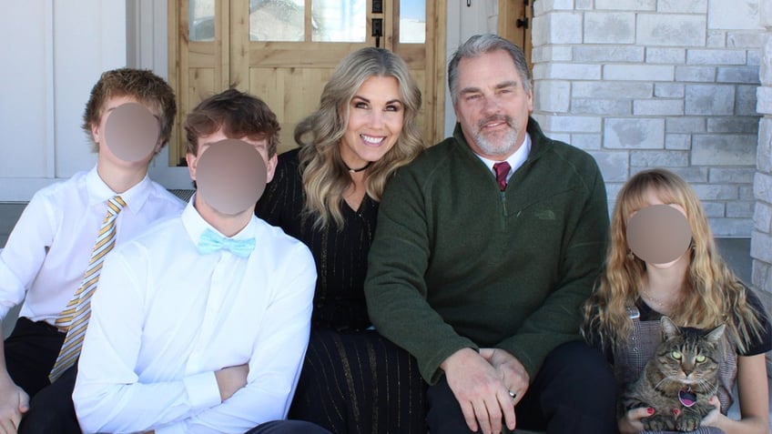 Olin and Kerilyn Johnson pose in front of their home.