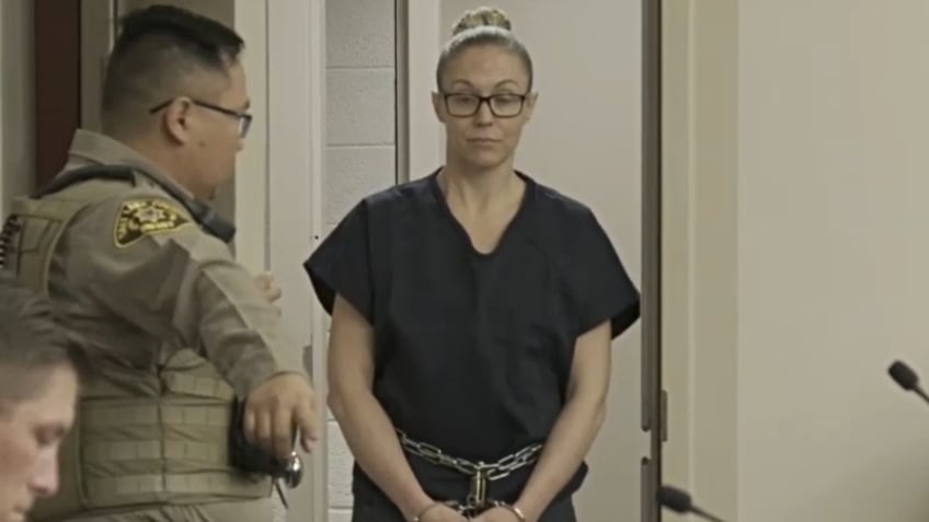 Jennifer Gledhill appears in court on Feb. 6, wearing a navy jumpsuit and shackles with her hair tied in a bun.