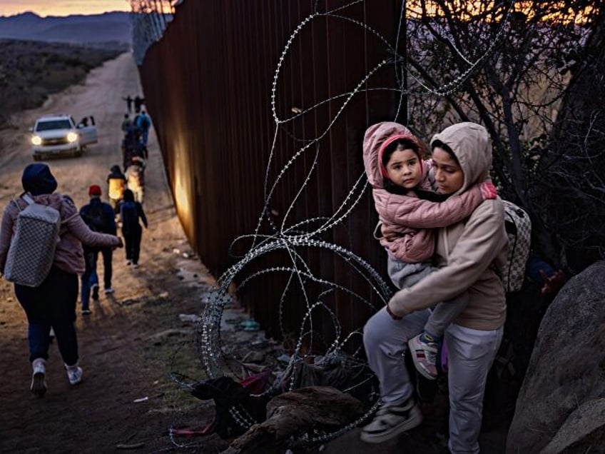 JACUMBA HOT SPRINGS, CALIFORNIA - JANUARY 03: Migrants cross through a gap in the US-Mexico border fence on January 3, 2024 in Jacumba Hot Springs, San Diego, California. (Photo by Qian Weizhong/VCG via Getty Images)