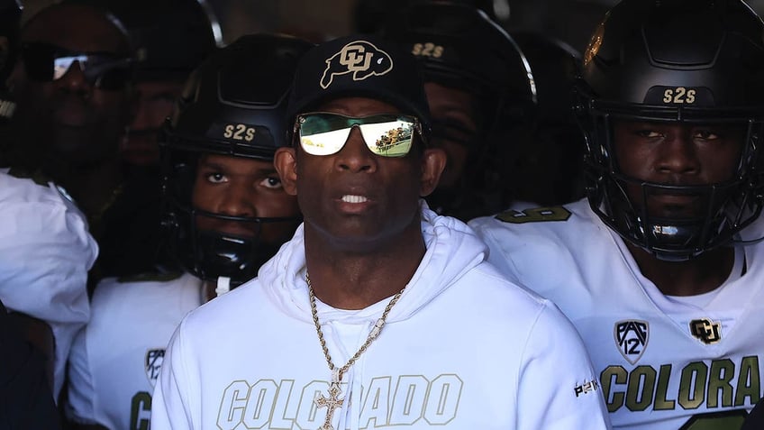 Deion Sanders looks on before a game