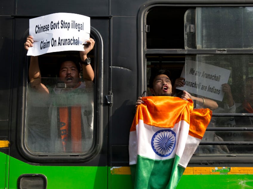 A small group of protestors from India’s northeastern Arunachal Pradesh state shout slog