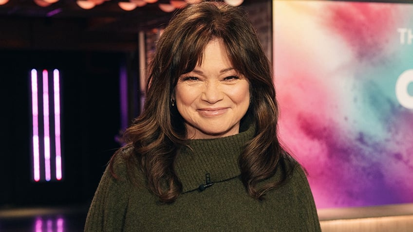 Valerie Bertinelli soft smiles in a green sweater