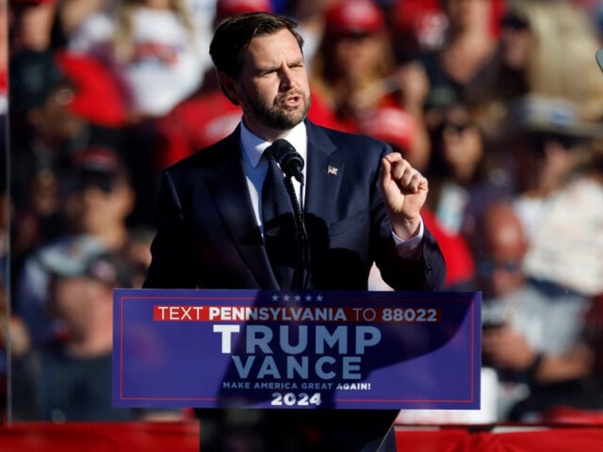 Republican vice presidential candidate Sen. JD Vance addresses a campaign rally from behin