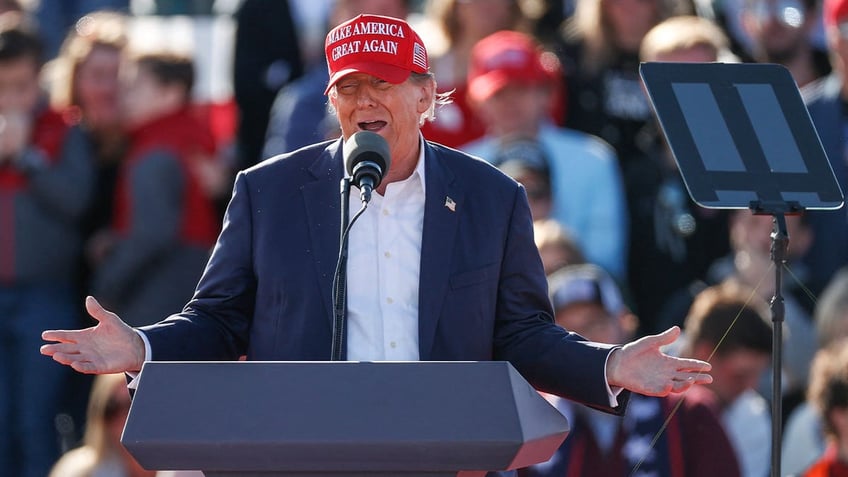 Donald Trump in red MAGA cap at March 2024 rally