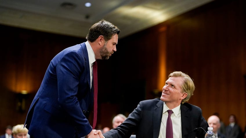 US Vice President JD Vance, left, and Elbridge Colby, under secretary of defense for policy nominee for US President Donald Trump, shake hands during a Senate Armed Services Committee confirmation hearing in Washington, DC, US, on Tuesday, March 4, 2025.