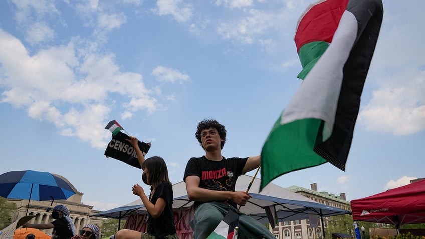 A protester holds a Palestinian flag as students rally on Columbia University campus