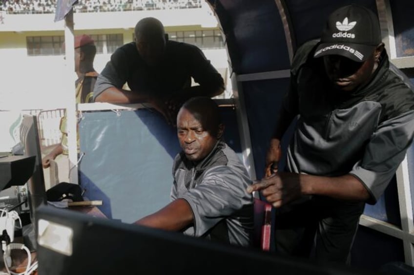 Referees watch the VAR screens at Senegal's National Wrestling Arena in Pikine