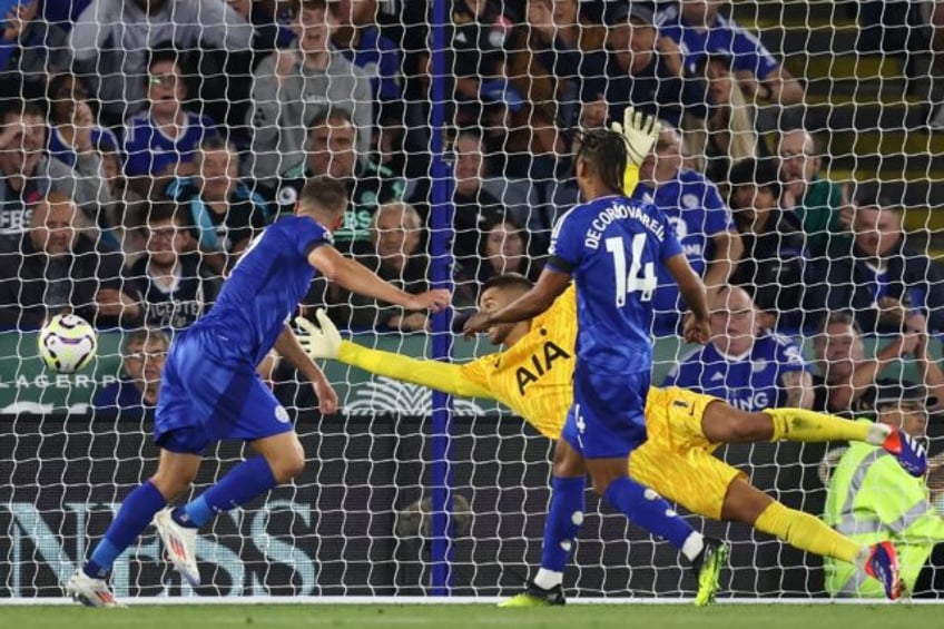 Leicester's Jamie Vardy (L) heads his side's equaliser against Tottenham