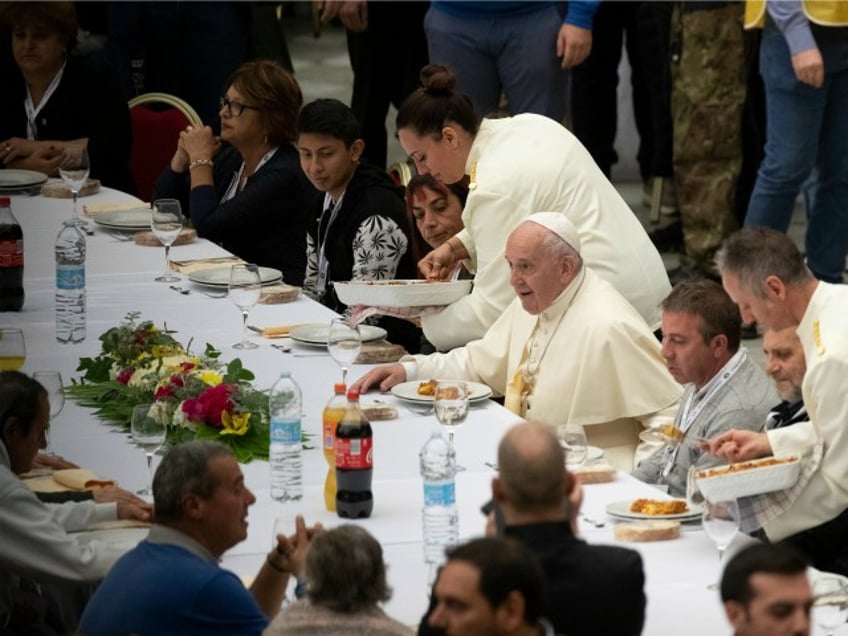 Pope Francis sits at a table during a lunch, in the Paul VI Hall at the Vatican, Sunday, Nov. 17, 2019. Pope Francis is offering several hundred poor people, homeless, migrants, unemployed, a lunch on Sunday as he celebrates the World Day of the Poor with a concrete gesture of charity in the spirit of his namesake, St. Francis of Assisi. (AP Photo/Alessandra Tarantino)