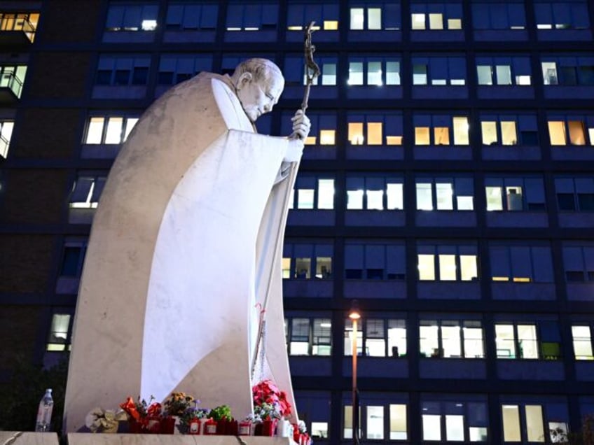 A picture shows a statue of Pope John Paul II outside the Gemelli hospital where Pope Fran