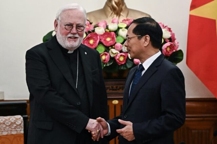 Vietnam's Foreign Minister Bui Thanh Son shakes hands with the Vatican's de facto foreign