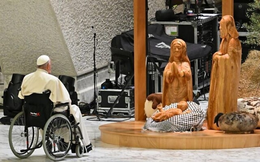 Pope Francis prays before the 'Nativity of Bethlehem 2024,' upon its inauguration in the Paul VI Hall, during the private audience with donors of the nativity scene and the lighting of the Christmas tree ceremony at St Peter's Square, in the Paul-VI hall at the Vatican on December 7, 2024. (Andreas Solaro/ AFP)