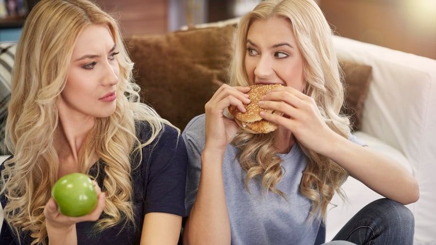 Twins eating meat and fruit