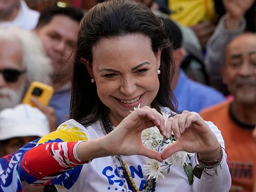 Opposition leader Maria Corina Machado gestures to supporters during a protest against Pre