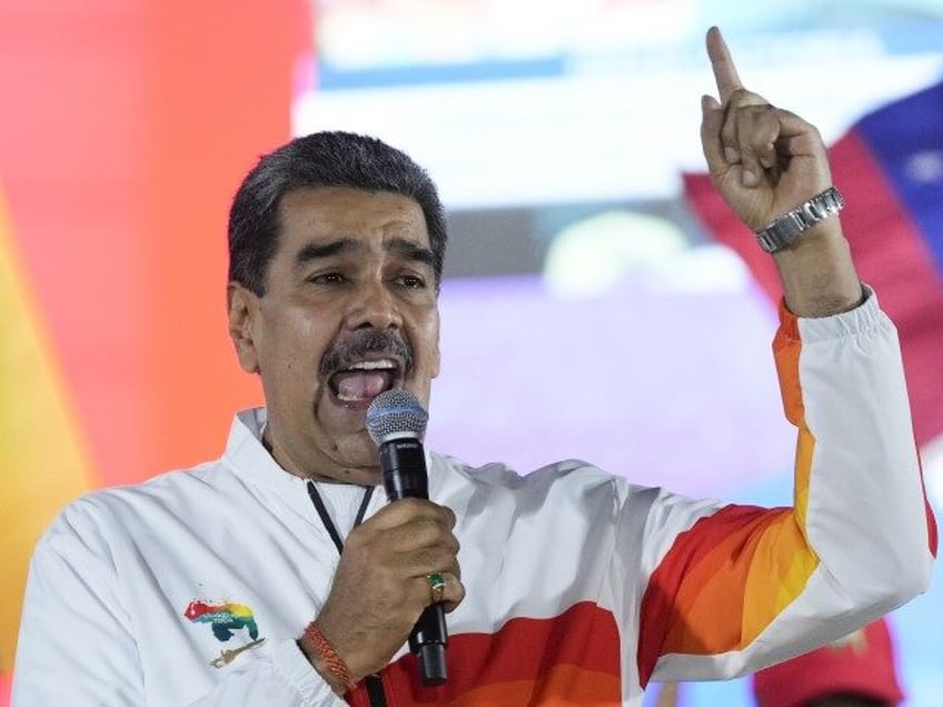 President Nicolas Maduro speaks to pro-government supporters after a referendum regarding