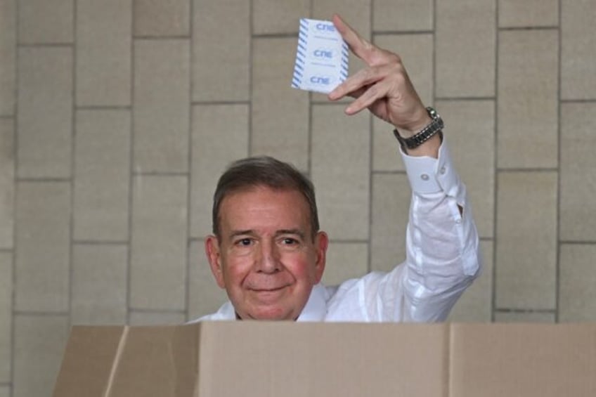 Venezuelan opposition presidential candidate Edmundo Gonzalez Urrutia shows his ballot as