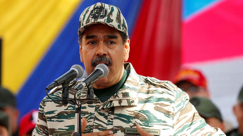 Venezuela's President Nicolas Maduro leads the celebration of the 22nd anniversary of late President Hugo Chavez's return to power after a failed coup attempt in 2002 wearing army fatigues and a matching baseball cap.