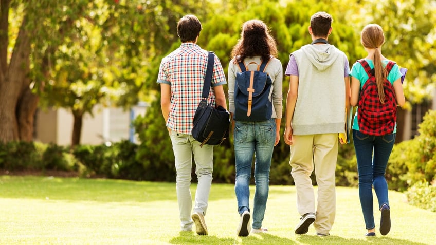 Students in college walking across a campus