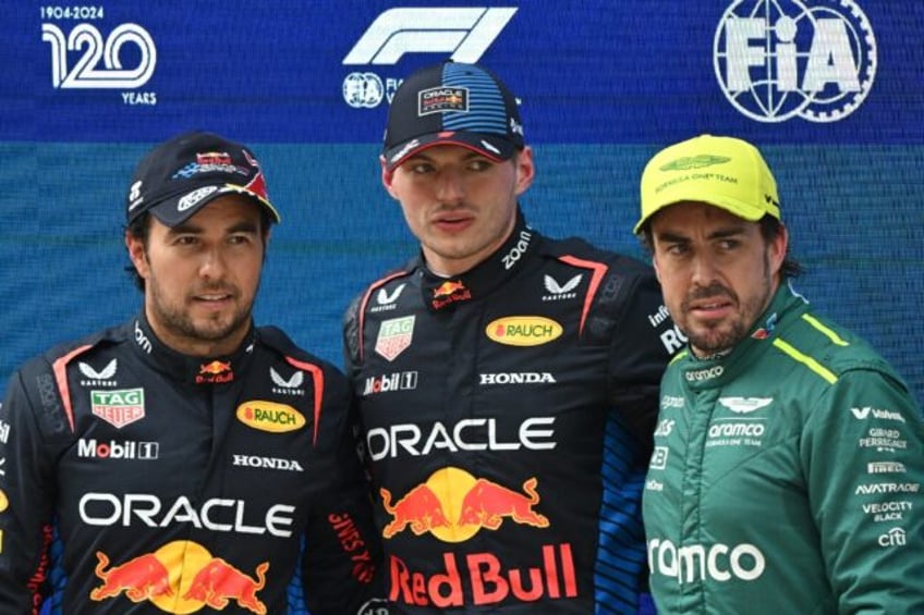 Max Verstappen (centre) celebrates pole position with Sergio Perez (left) and n Alonso