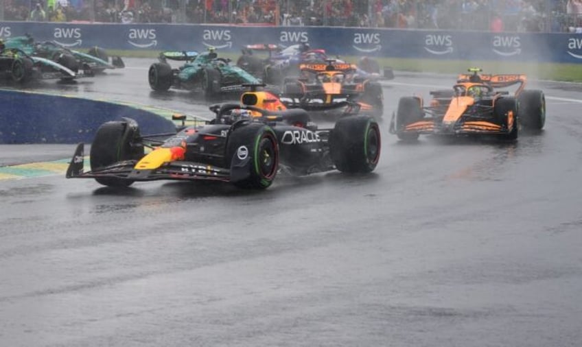 Max Verstappen leads Lando Norris as the spray flies at the Canadian Grand Prix