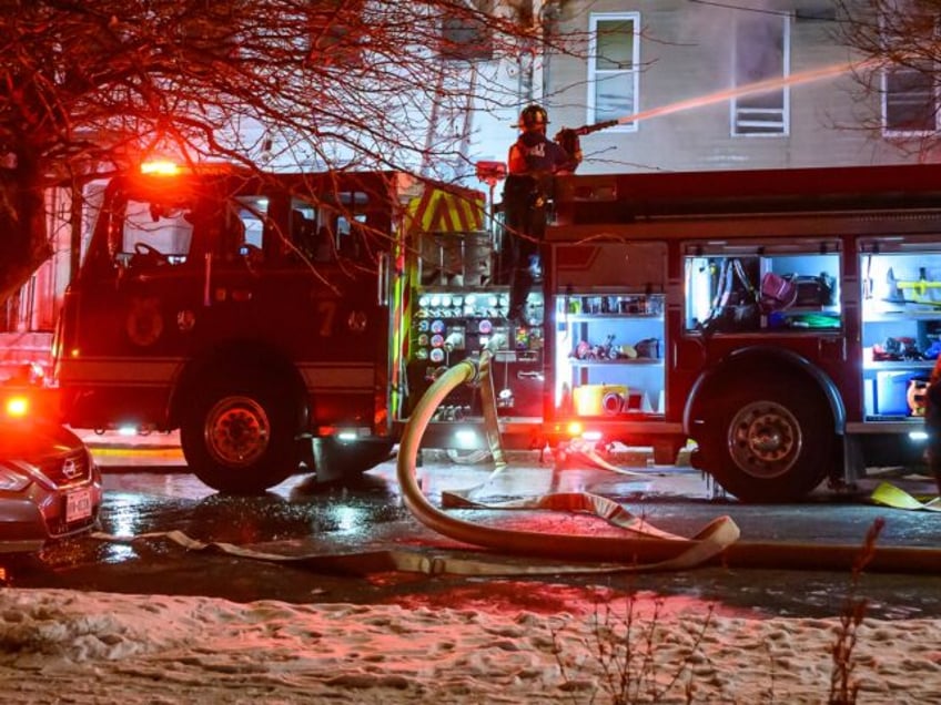 ALBANY, NY DECEMBER 25: Firefighters battle a blaze that started at 530 Second St. and spr