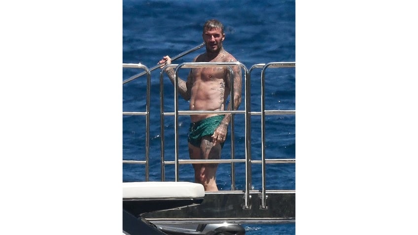 David Beckham rinses off on a yacht