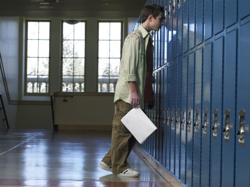 Teen Boy Leaning on Locker