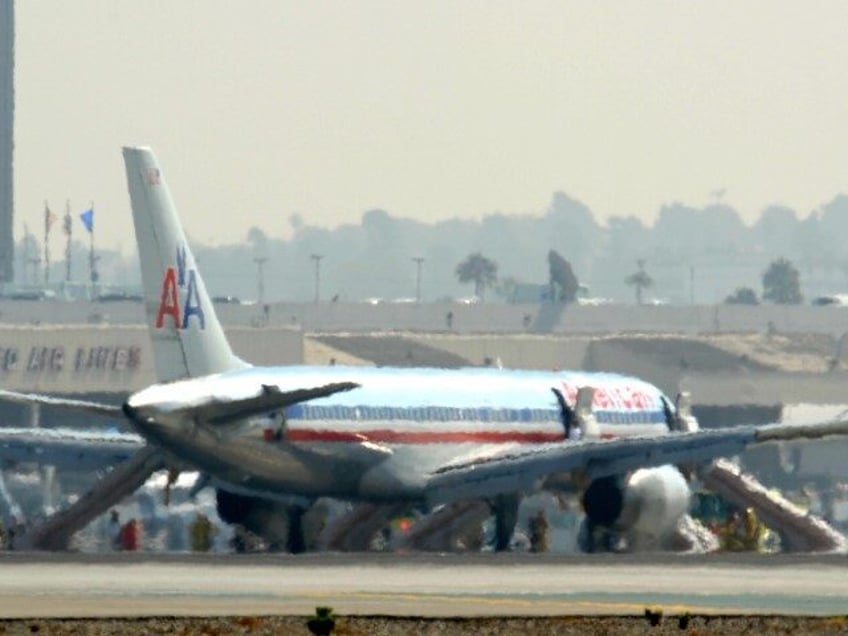 Passengers deplane from an American Airlines commerical flight after it made an emergency