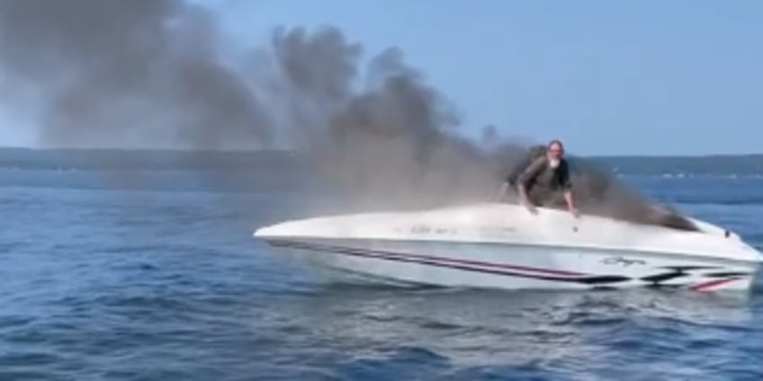 video captures michigan boaters diving into water before boat is engulfed in flames