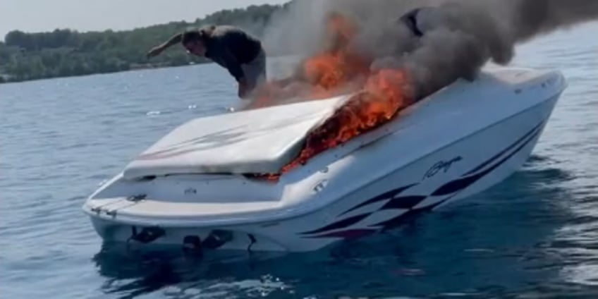 video captures michigan boaters diving into water before boat is engulfed in flames