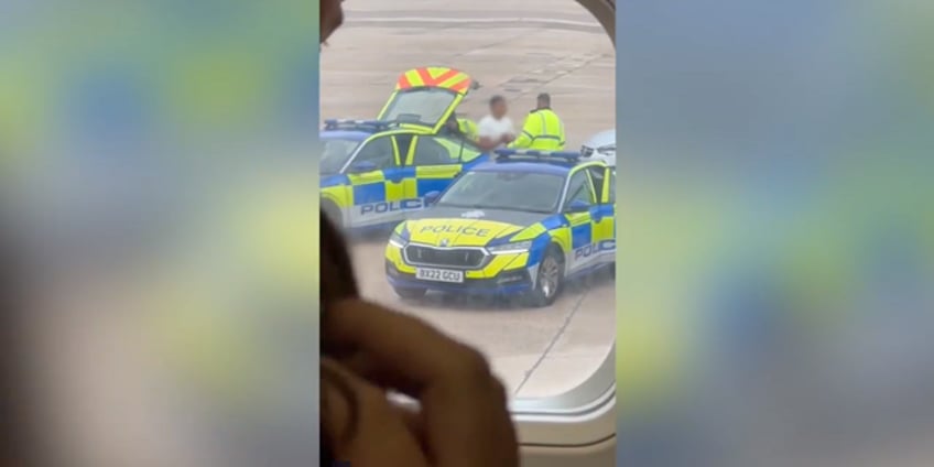 video captures moment armed police escort man from plane due to explosive device threat