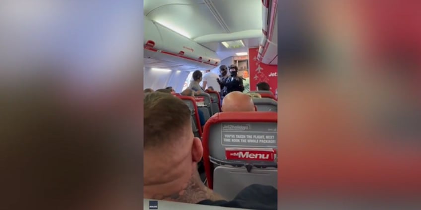 video captures moment armed police escort man from plane due to explosive device threat