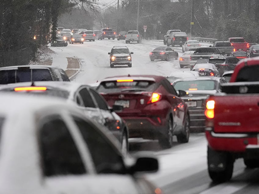 Cars backup near a hill with snow and ice on the road during a winter storm on Tuesday, Ja