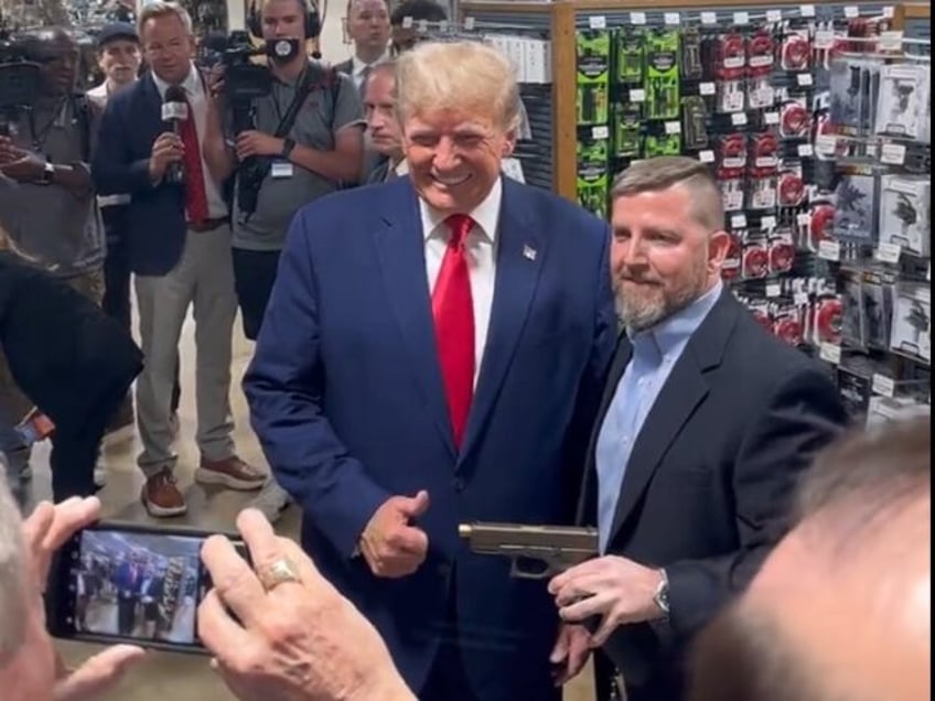 video donald trump poses with commemorative glock ahead of campaign speech