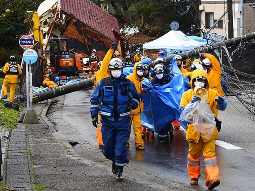 Rescuers carry away the body of victim who was retrieved from a landslide site in the Kawashima district in the city of Anamizu, Ishikawa Prefecture, on January 6, 2024, after a major 7.5 magnitude earthquake struck the Noto region on New Year's Day. Rescuers sifted through rubble on January 6 …