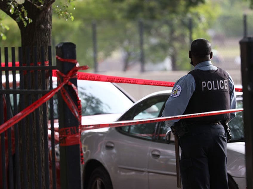 Police investigate a crime scene where three people were shot at the Wentworth Gardens hou