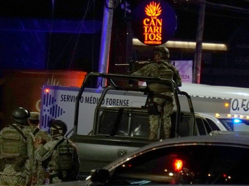 Soldiers of the Mexican Army and public security agents stand guard outside the Los Cantar