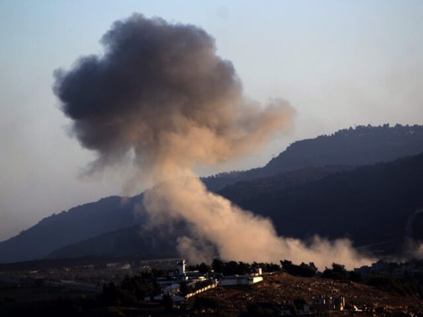 02 October 2024, Lebanon, Kfarkela: Heavy smoke billows from an Israeli air raid on an are