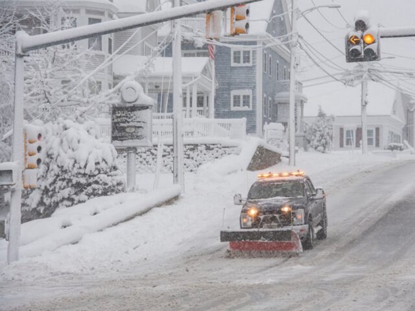 A snowplow clears snow from Broadway in Methuen, Massachusetts on January 7, 2024. Forecasters warned on January 5 that a deluge of snow and wintery conditions could bring travel chaos to the US northeast this weekend, with some 25 million people subject to a storm warning. (Photo by Joseph Prezioso …