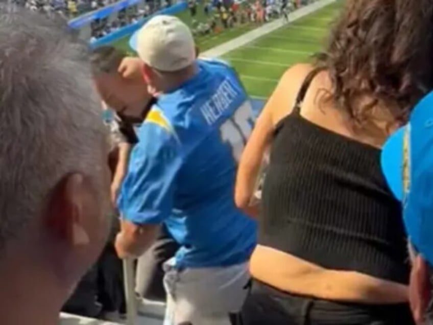 video raiders fan pushed down steps during fight with chargers fan