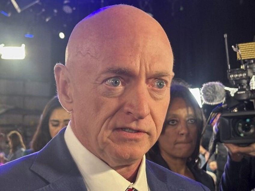 Sen. Mark Kelly, D-Ariz., speaks to reporters in the spin room after a CBS News vice presi