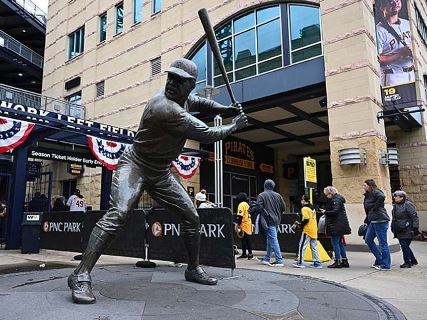 Fans enter the ballpark past the Willie Stargell statue before the Pittsburgh Pirates home