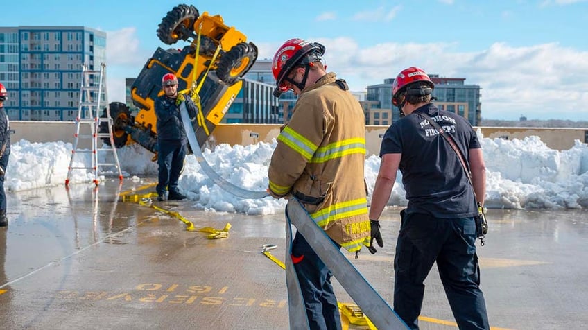 Rescue crews work to secure the machine