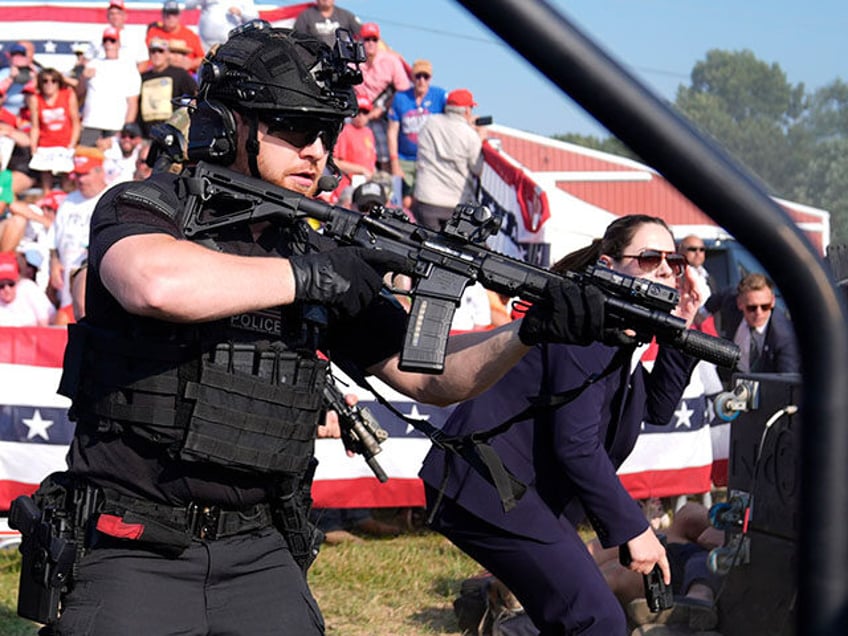 U.S. Secret Service agents surround the stage as other agents cover Republican presidentia