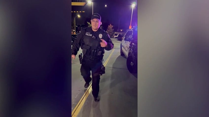 Officer approaches during a traffic stop at night