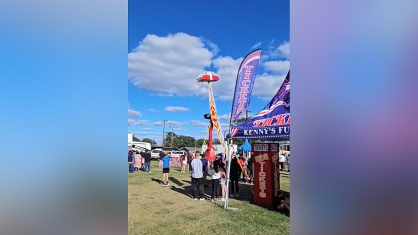 video shows texas carnival worker clinging to amusement ride in midair to protect child after mishap