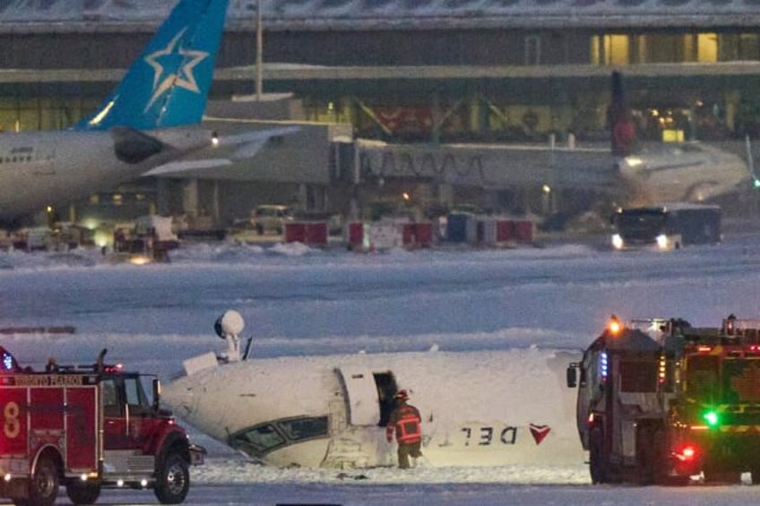 A Delta plane on its roof after crashing on landing at Toronto Pearson Airport