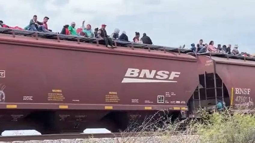 video shows train in mexico filled with migrants riding on top as it heads to us southern border